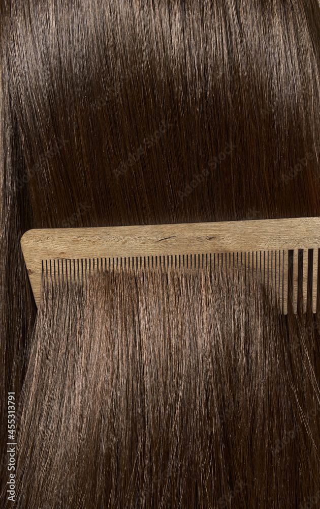 Combing healthy long straight female hair. Close up Combing healthy long straight female hair. Close up