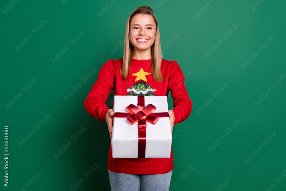 Portrait of attractive cheerful blonde girl holding giftbox tradition isolated over green color background Portrait of attractive cheerful blonde girl holding giftbox tradition isolated over green color background