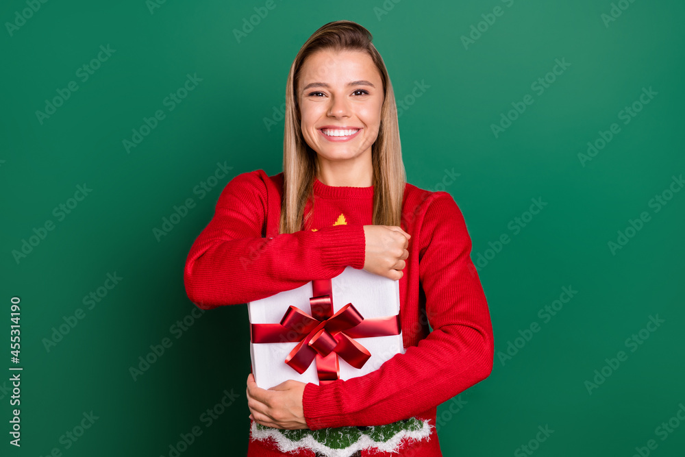 Portrait of attractive cheerful girl hugging giftbox festal day custom isolated over green color background Portrait of attractive cheerful girl hugging giftbox festal day custom isolated over green color background