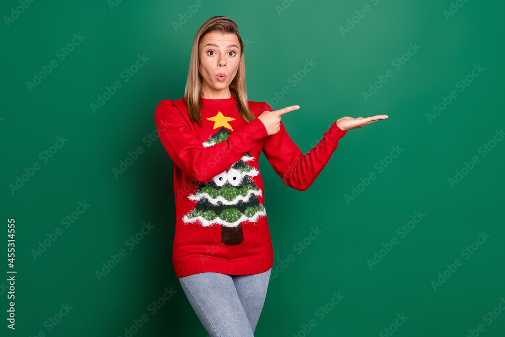 Portrait of attractive trendy amazed blonde girl holding on palm copy space pout lips present isolated over green color background