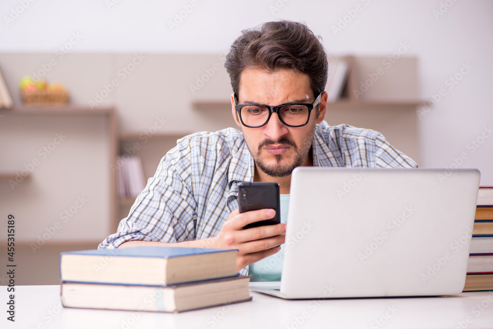 Young male student preparing for exams at home Young male student preparing for exams at home
