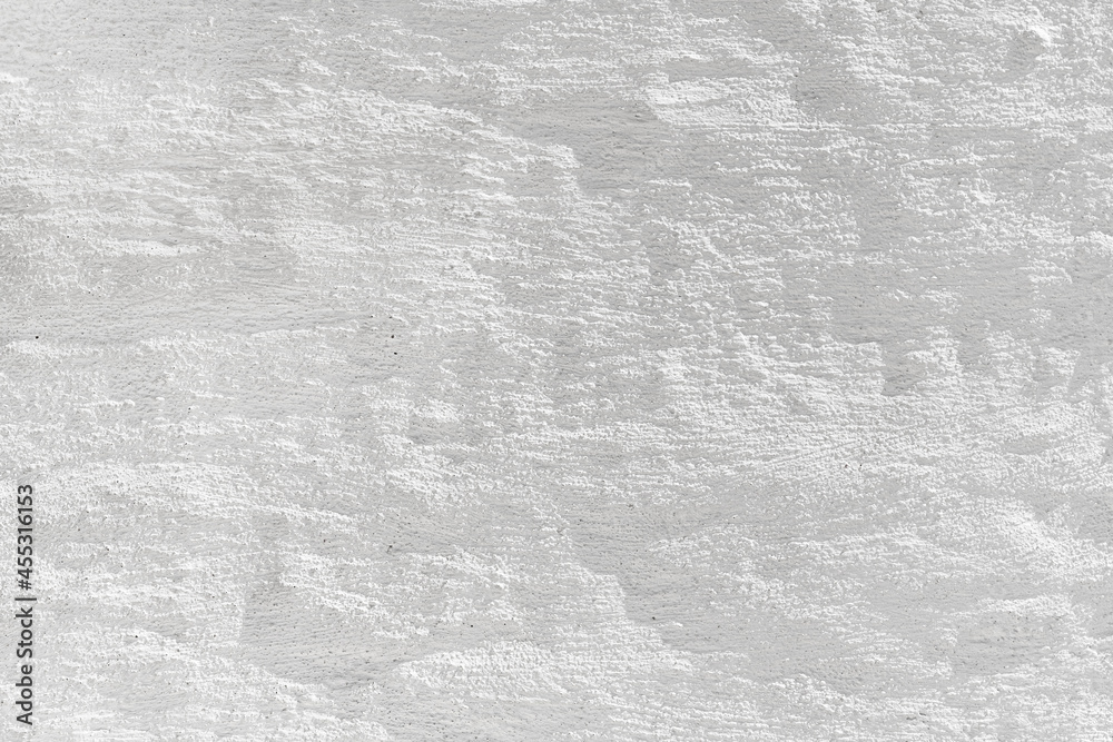 Naklejka premium Embossed textured white grunge wall surface painted with whitewash could be used like a layout or background.