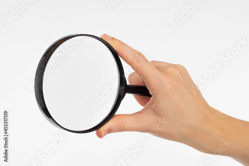 Hand with a magnifying glas...