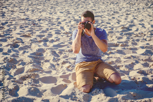 Silhouette of young photographer on the beach