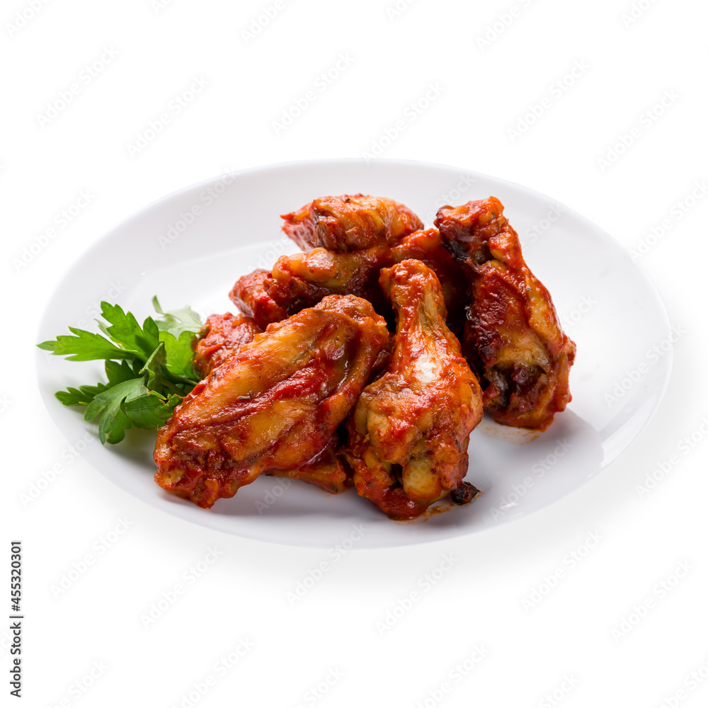 chicken wings in barbecue sauce on white plate isolated on white background side view chicken wings in barbecue sauce on white plate isolated on white background side view