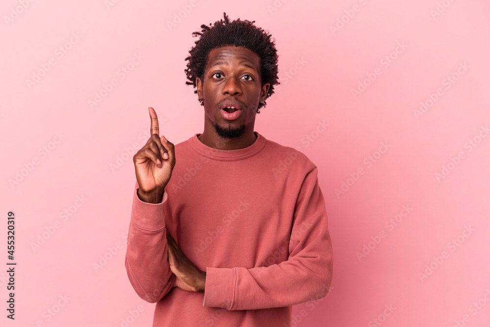 Young african american man isolated on pink background having some great idea, concept of creativity. Young african american man isolated on pink background having some great idea, concept of creativity.