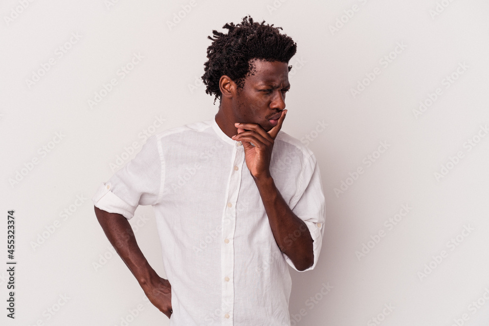Young african american man isolated on white background keeping a secret or asking for silence. Young african american man isolated on white background keeping a secret or asking for silence.