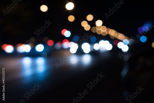 Bokeh lighting from car lights on the road at night.