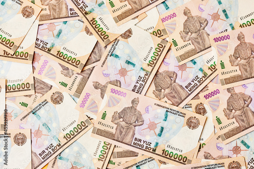 Pile of Uzbek sum currency money bill. A stack of one hundred thousand Uzbek sum. Uzbek money. 100000 sum