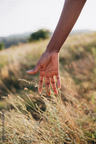 A hand of a black young woman nature summer autumn unity concept human eco