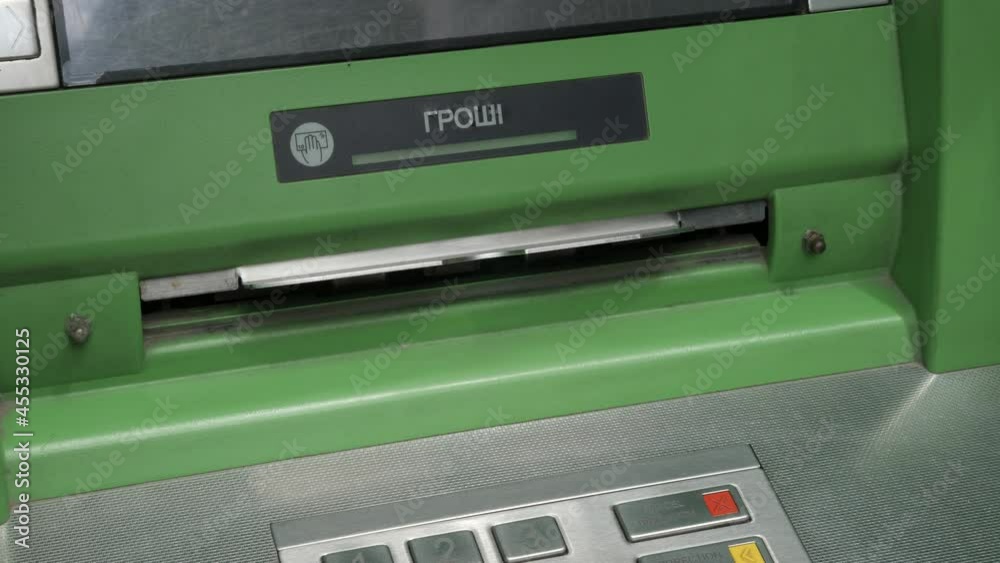 Take cash machine banknote Ukrainian hryvnias bank atm money. Cash withdraw money Ukranian cash ATM machine. Close up hand taking cash bank withdrawal service with Ukranian text groshi meaning money