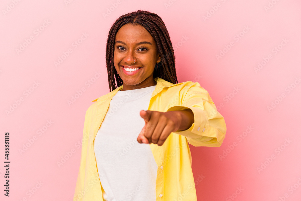 Young african american woman isolated on pink background cheerful smiles pointing to front. Young african american woman isolated on pink background cheerful smiles pointing to front.