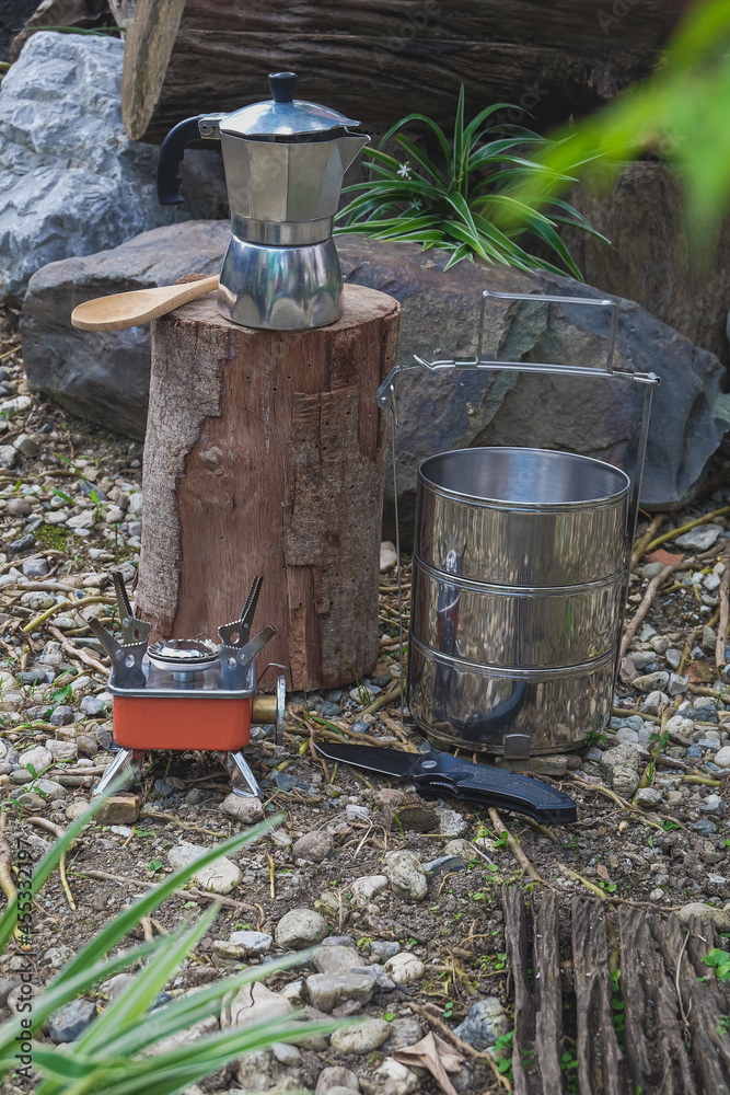 Fototapeta premium Pinto name of camping pot for cooking with moka pot coffee maker on a mountain day.