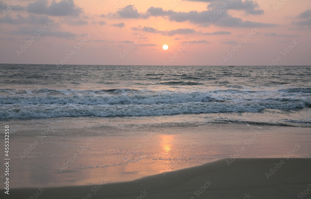 Pink sunset on Varca beach in South Goa in India