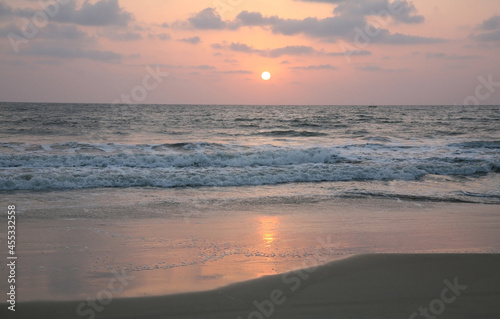 Pink sunset on Varca beach in South Goa in India