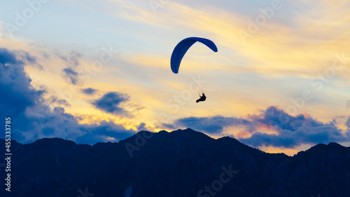 Paraglider wing with sunset clouds