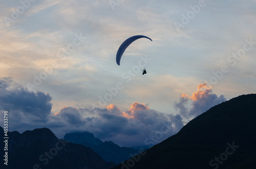 Paraglider pilot enjoys sunset flight