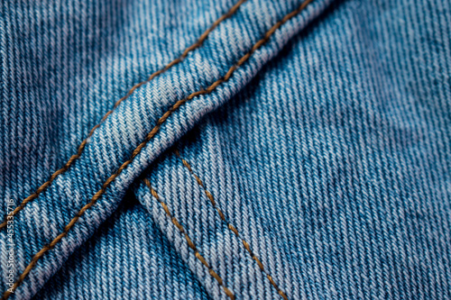 Close up of a seam on a new blue jean texture with copy space 