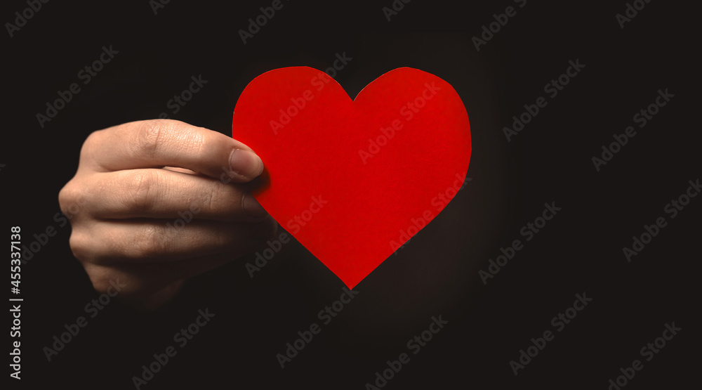 Hand holding paper heart on black background. Health insurance, organ donor day, charity. World health day, world mental health day, world heart day, gratitude and all lives matter background photo Hand holding paper heart on black background. Health insurance, organ donor day, charity. World health day, world mental health day, world heart day, gratitude and all lives matter background photo