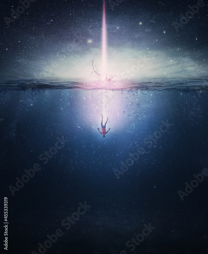 Surreal scene with a person falling underwater, like a comet from the night sky crashing into the ocean waters. Fantasy and mystical concept, magical adventure. photo