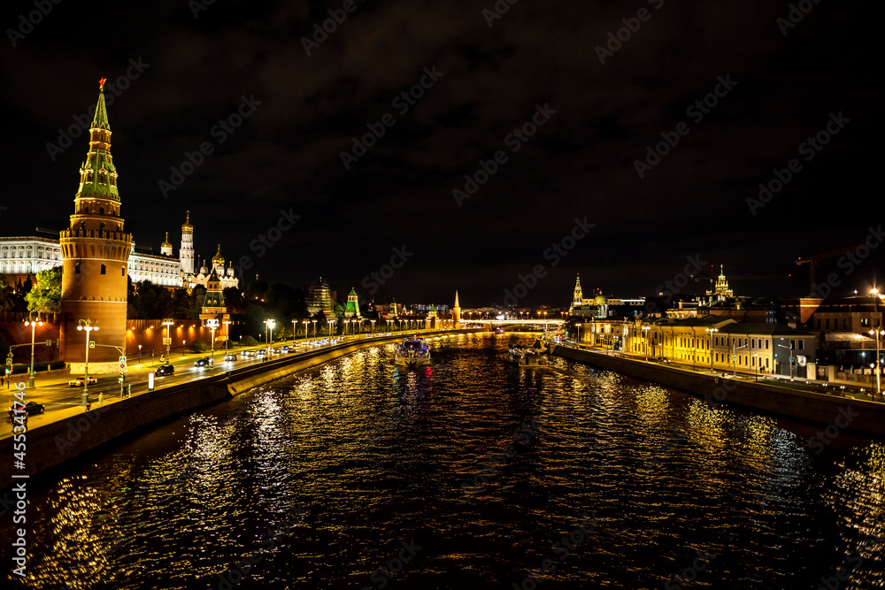 Obraz premium landscape with night river lights reflected in the river and the ancient Kremlin with towers on the bank 