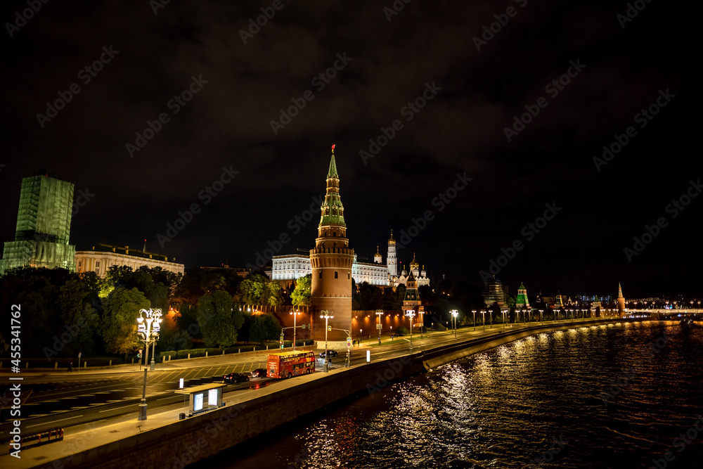 landscape with night river lights reflected in the river and the ancient Kremlin with towers on the bank landscape with night river lights reflected in the river and the ancient Kremlin with towers on the bank