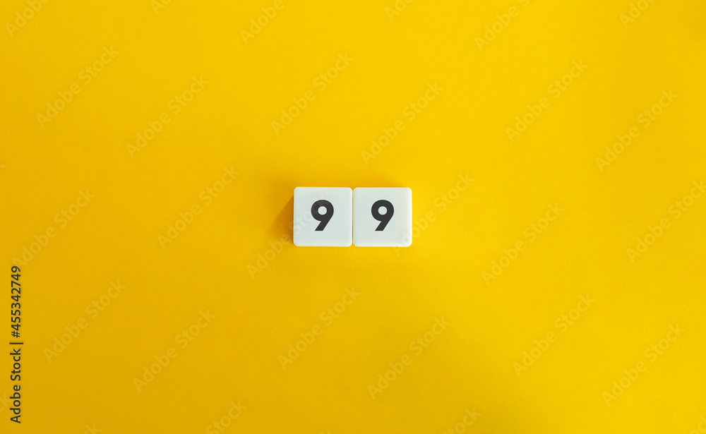 99 number banner and concept. Block letter tiles on bright orange background. Minimal aesthetics. 99 number banner and concept. Block letter tiles on bright orange background. Minimal aesthetics.
