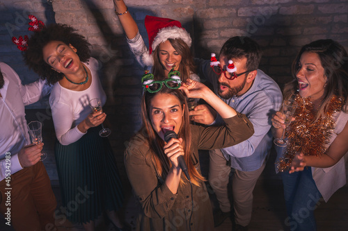 Friends having New Year's Eve karaoke party