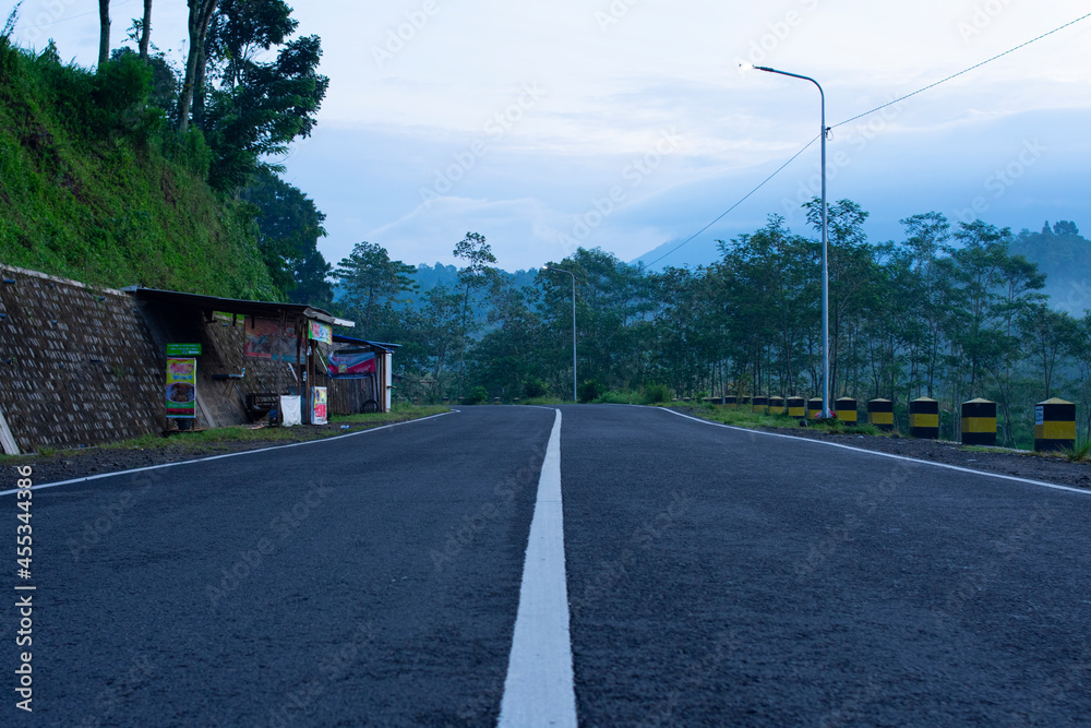 white-lined straight road in the countryside.