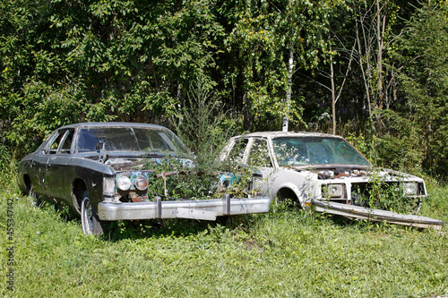 Old abandoned rusty vehicles, crushed cars in junkyard. Cars recycling concept.