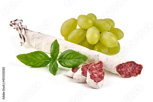 Traditional Spanish Fuet thin dried sausage with slices, Close-up, isolated on a white background. photo