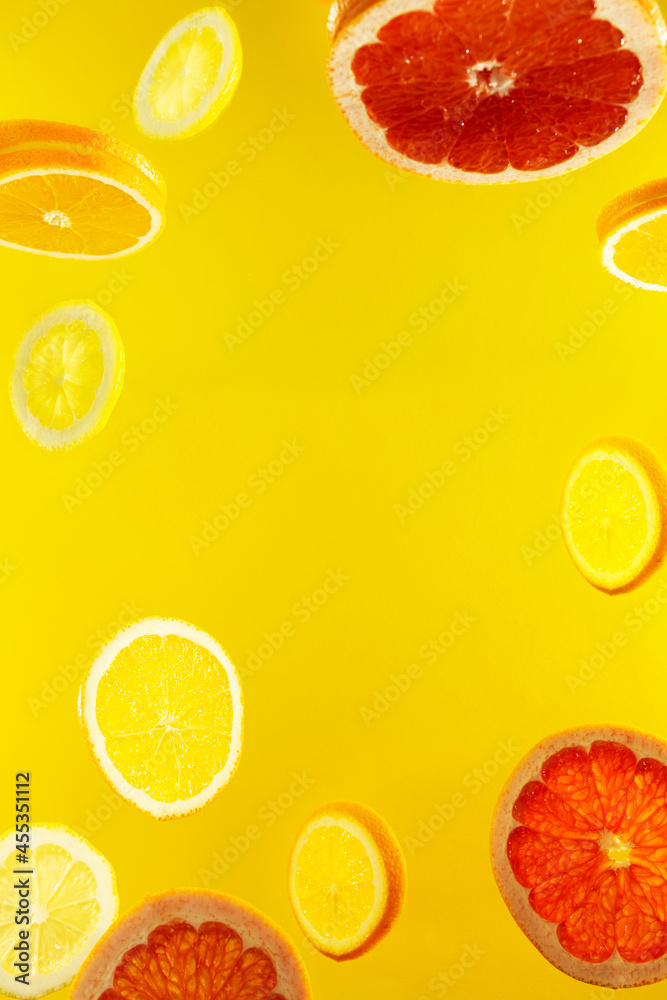 A closeup shot of a lemon and a grapefruit slices against a yellow background A closeup shot of a lemon and a grapefruit slices against a yellow background