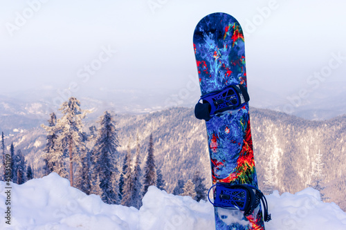 Blue snowboard on the background of the mountains