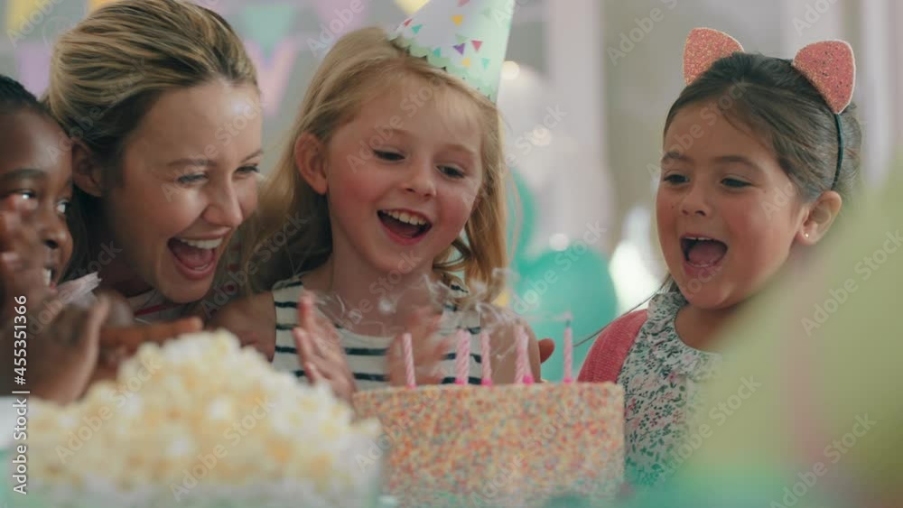 cute birthday girl blowing candles on cake celebrating party with friends happy children having fun celebration at home 4k cute birthday girl blowing candles on cake celebrating party with friends happy children having fun celebration at home 4k