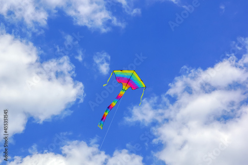 a kite with rainbow colors in the sky
