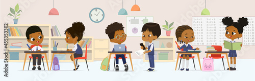 Dark skin children studying at multiracial elementary school sitting at tables talking together at classroom vector flat illustration. Diverse schoolboy and schoolgirl classmates wearing uniform photo