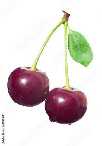 Dark cherries with leaf isolated on white background.