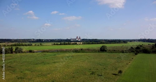 River Mulde with an extensive floodplain landscape on a summer afternoon. In the background the skyline of the city of Wurzen (Saxony, Germany)