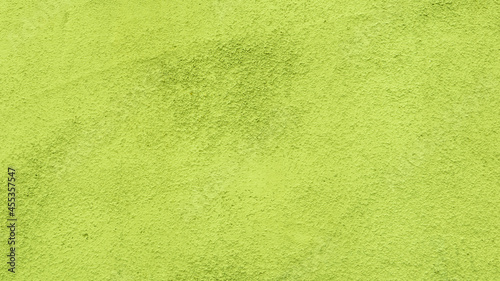 Abstract background from yellow-green plaster.