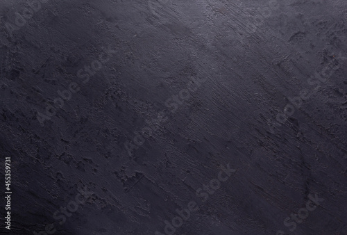 Black slate stone background texture. Putty or plaster wall