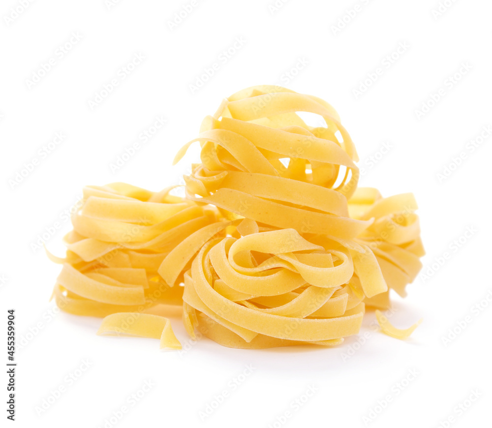 Fettuccine raw pasta italian food isolated at white background. Pasta tagliatelle on white Fettuccine raw pasta italian food isolated at white background. Pasta tagliatelle on white