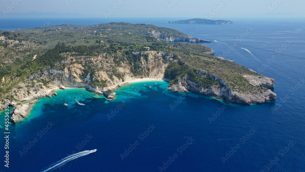 Aerial drone photo of beautiful azure deep turquoise bay and beach of Galazio next to famous Avlaki beach in Ionian island of Paxos, Greece