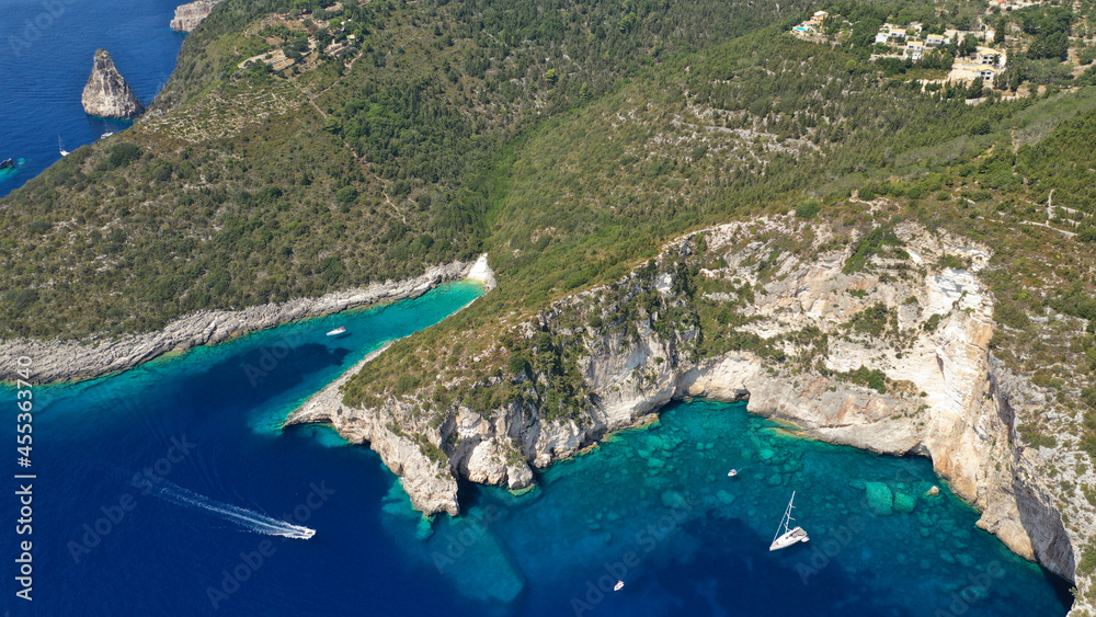 Fototapeta premium Aerial drone photo of tropical exotic paradise bay with deep turquoise sea and caves forming a blue lagoon visited by luxury yachts and sail boats