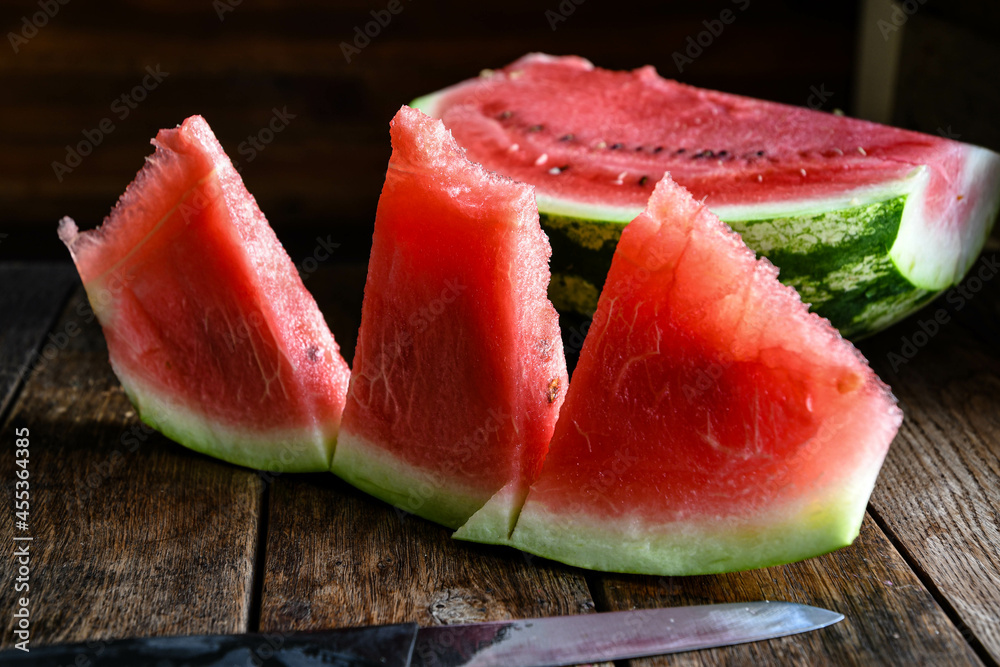 Ripe, sweet, sliced watermelon on a wooden table.