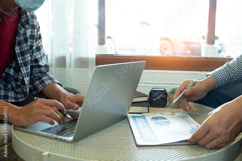 businessman working use laptop in office for discussing documents and ideas , with soft focus, vintage tone