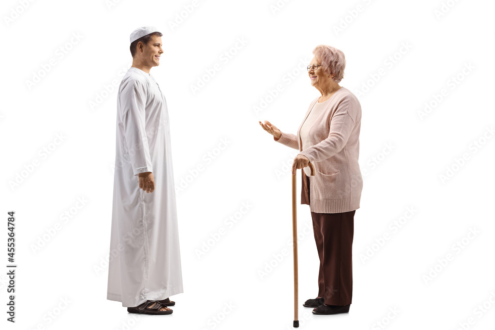 Full length profile shot of a an elderly woman talking to a young man in ethnic clothes