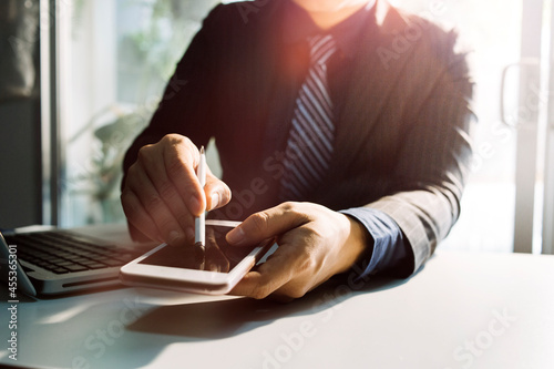 Business people using tablets And using his finger to touch the screen With a business graph showing up in a virtual screen.New startup ideas and business growth concept.