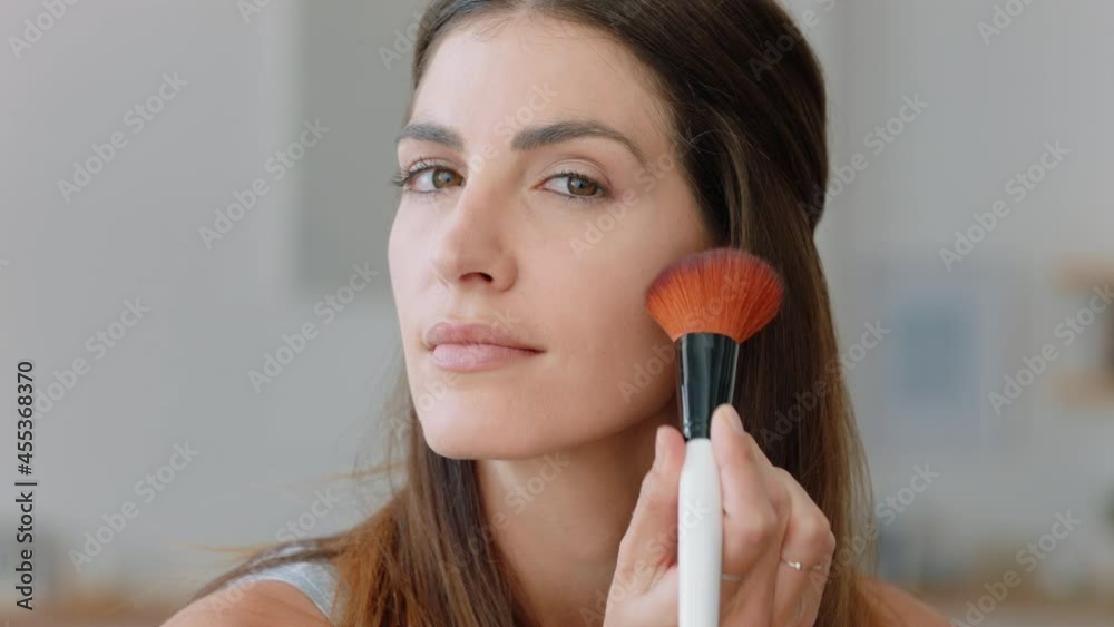 portrait beautiful young woman applying makeup getting ready at home looking in mirror enjoying natural complexion feminine beauty 4k footage