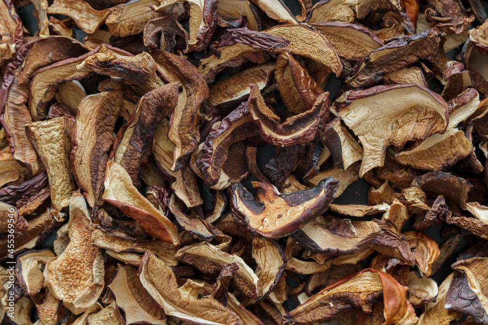 texture background: dried mushrooms Imleria badia (bay bolete) and Boletus edulis (penny bun). Dehydrated mushrooms for cooking top view texture background: dried mushrooms Imleria badia (bay bolete) and Boletus edulis (penny bun). Dehydrated mushrooms for cooking top view