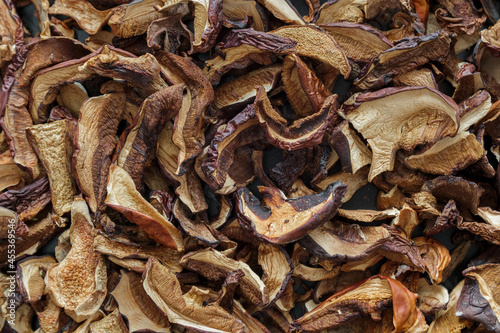 texture background: dried mushrooms Imleria badia (bay bolete) and Boletus edulis (penny bun). Dehydrated mushrooms for cooking top view